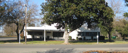 A large tree in front of the Biggs Community Hall